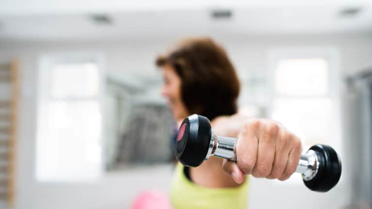 A woman lifting hand weights.