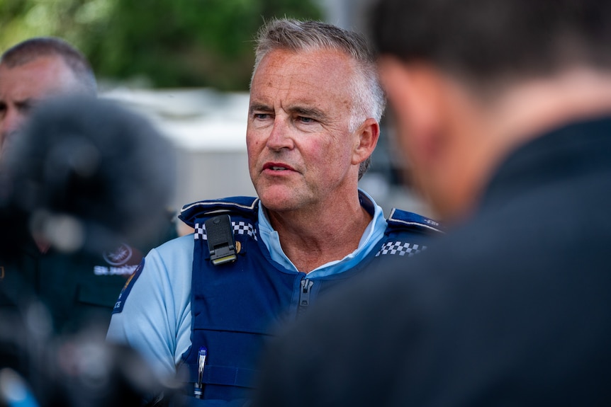 A close-up shot of a policeman speaking