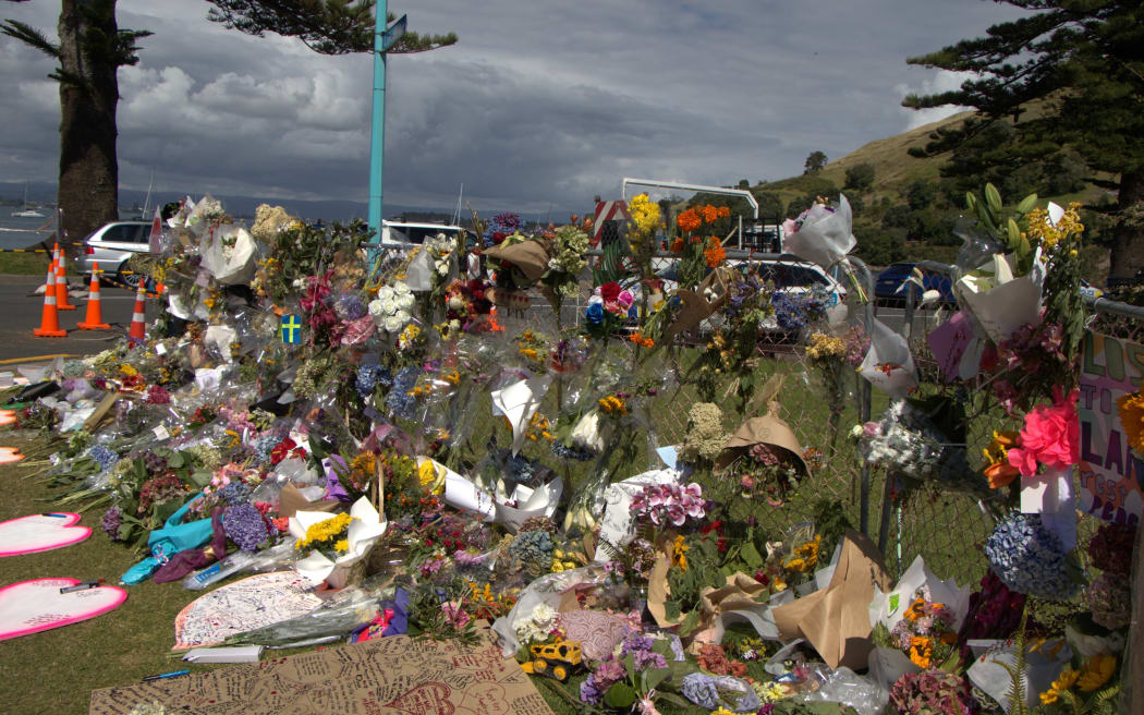 Bouquets and tributes at the Mount Maunganui landslide cordon.