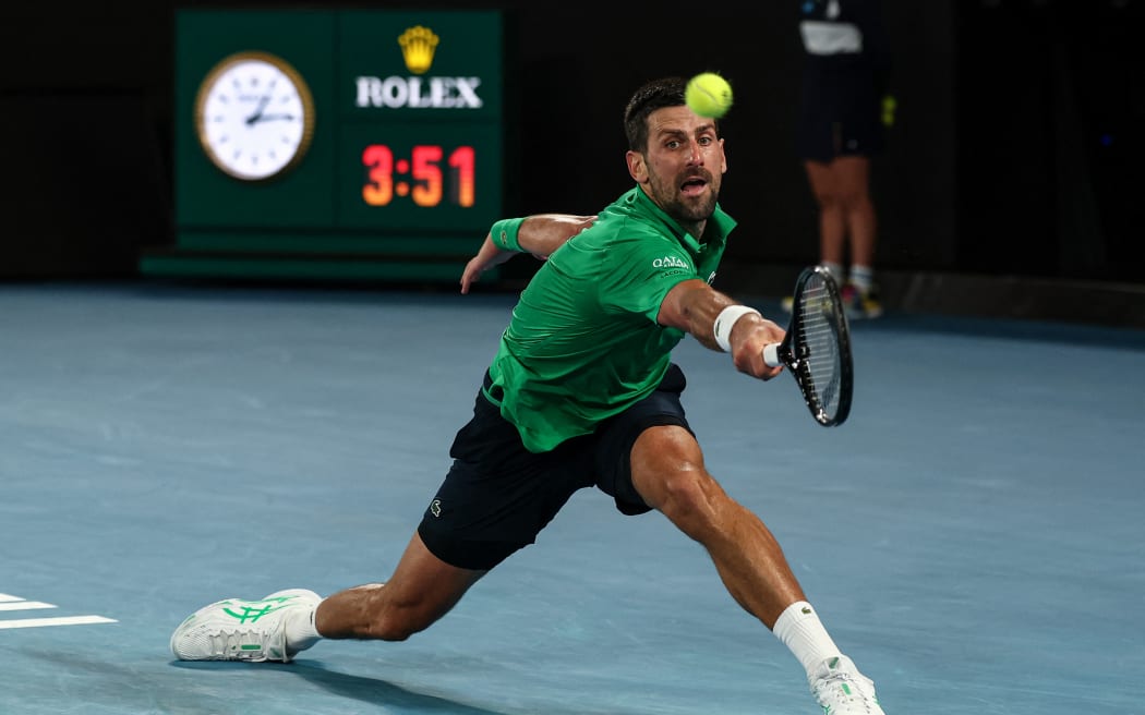 Serbia's Novak Djokovic hits a return to Italy's Jannik Sinner during their men's singles semi-final match on day thirteen of the Australian Open tennis tournament in Melbourne on January 31, 2026.
