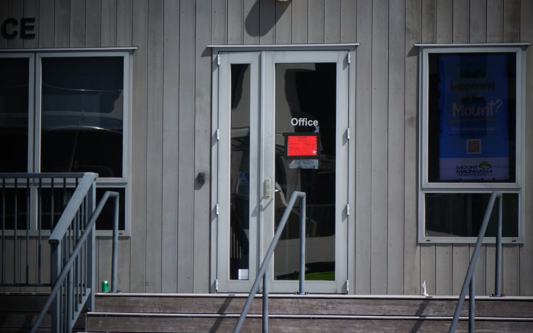 A red sticker on the door of the Mt Maunganui Surf Lifesaving Club.