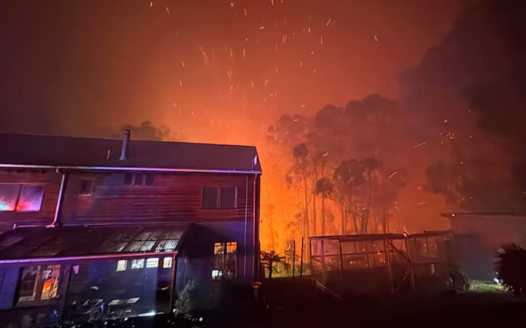 Fire burns close to a home near Gellibrand in Victoria's Otways