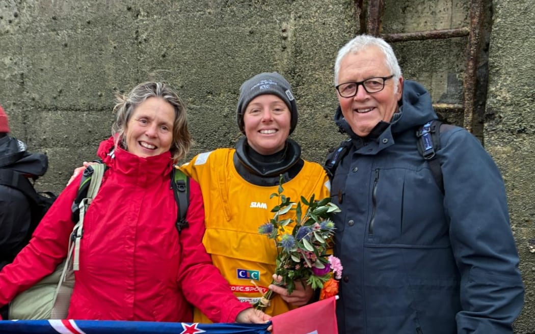 Rebecca Gmuer-Hornell (C), from Ōpua, in the Bay of Islands, with her parents Manuela Gmuer-Hornell (L) and Chris Hornell in France after setting two round-the-world records.