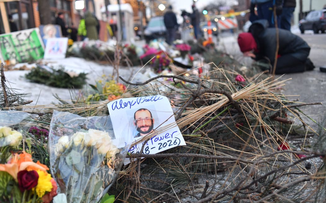 Mourners gather at a makeshift memorial in the area where Alex Pretti was shot dead a day earlier by federal immigration agents in Minneapolis, Minnesota, on January 25, 2026. On January 24, federal agents shot dead US citizen Alex Pretti, a 37-year-old ICU nurse, while scuffling with him on an icy roadway, less than three weeks after an immigration officer shot and killed Renee Good, also 37, in her car.
His killing sparked new protests and impassioned demands by local leaders for the Trump administration to end its operation in the city. (Photo by Octavio JONES / AFP)