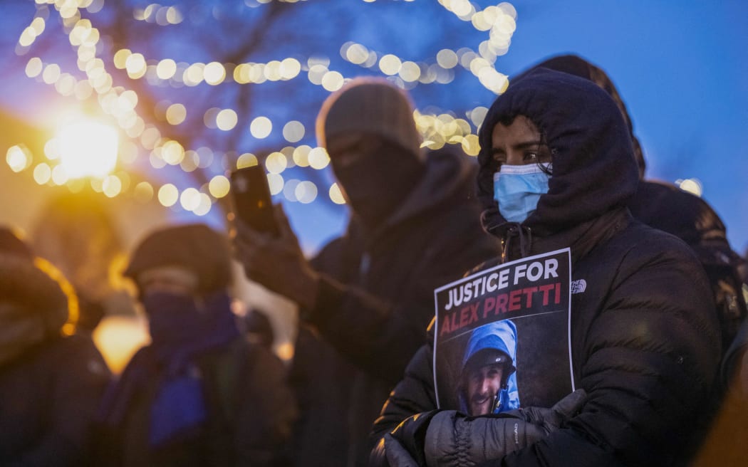 People mourn at a makeshift memorial in the area where 37-year-old Alex Pretti was shot dead by federal immigration agents earlier in the day in Minneapolis, on 24 January, 2026.