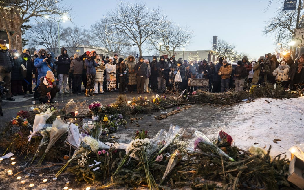 People mourn at a makeshift memorial in the area where 37-year-old Alex Pretti was shot dead by federal immigration agents earlier in the day in Minneapolis, on 24 January, 2026.