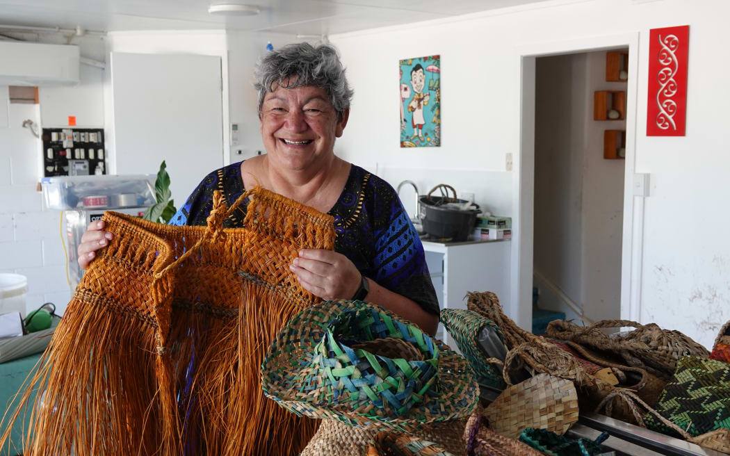 Rongoā Māori practitioner Donna Kerridge attempts to rescue raranga (weaving) soaked by floodwaters that swept through the ground floor of her Ōakura home.