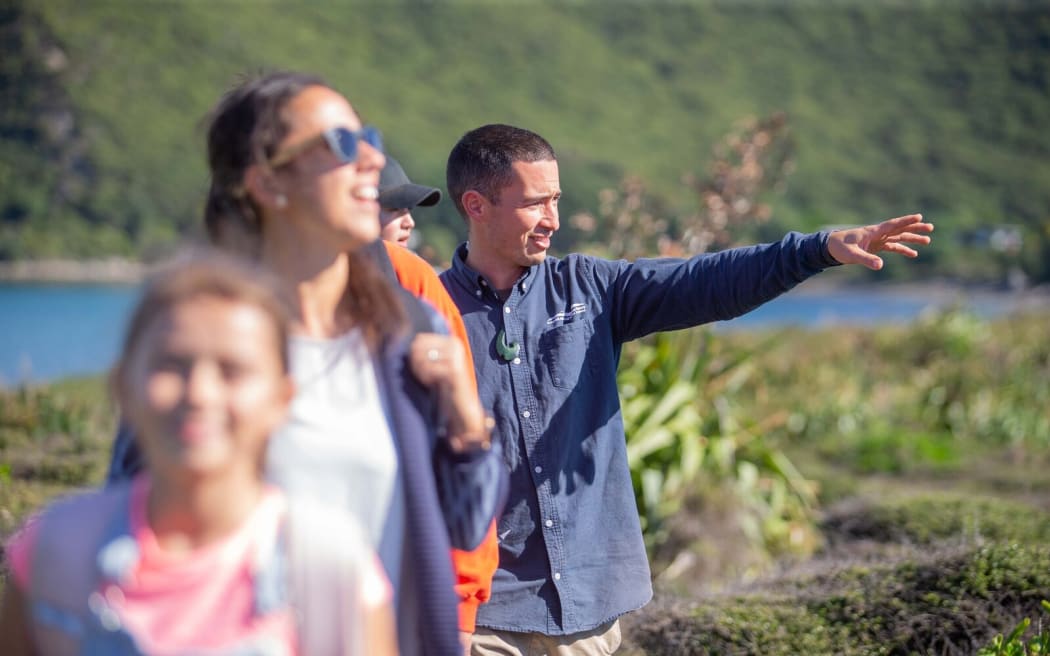 Manaaki Barrett guides a group of visitors on predator-free Kapiti Island.