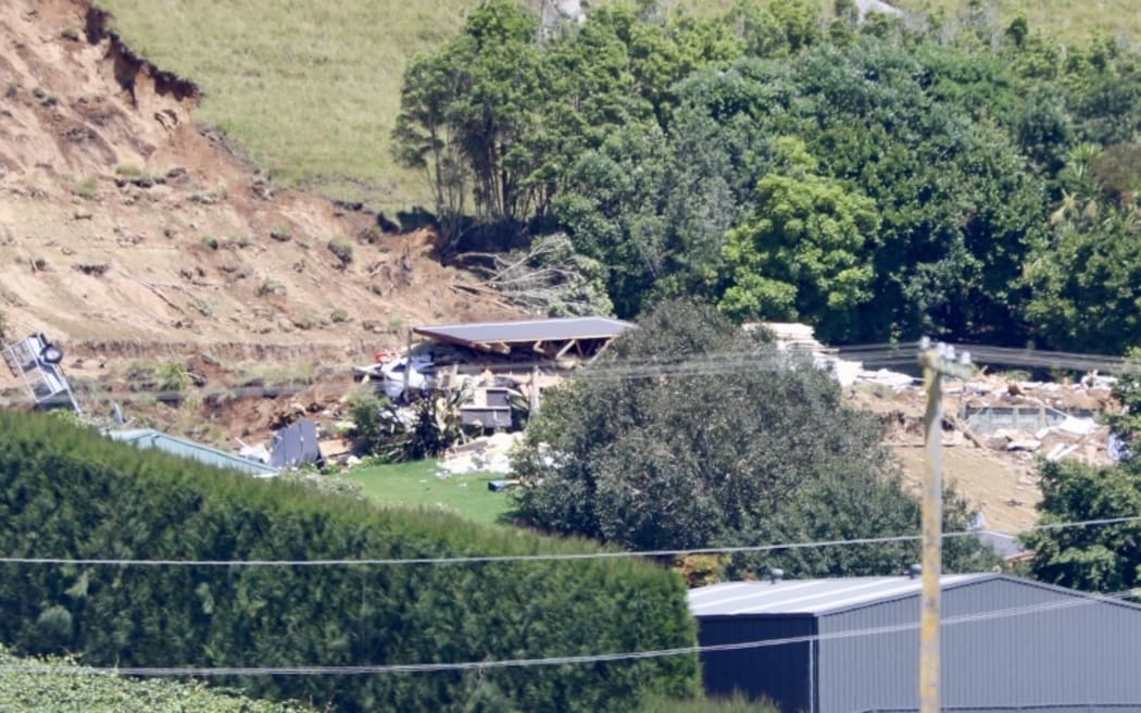 Damaged property from landslide at Welcome Bay from across a field outside of the cordon.