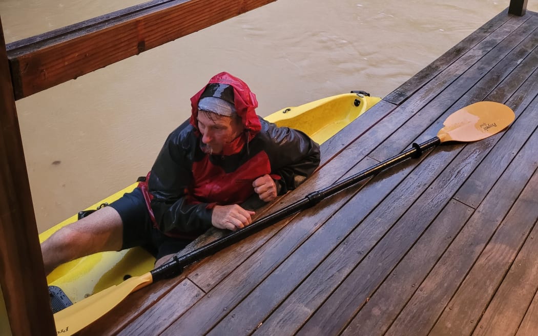 John Welch paddled through fast-flowing floodwaters to rescue his daughter and her partner from their deck of their Coromandel home.