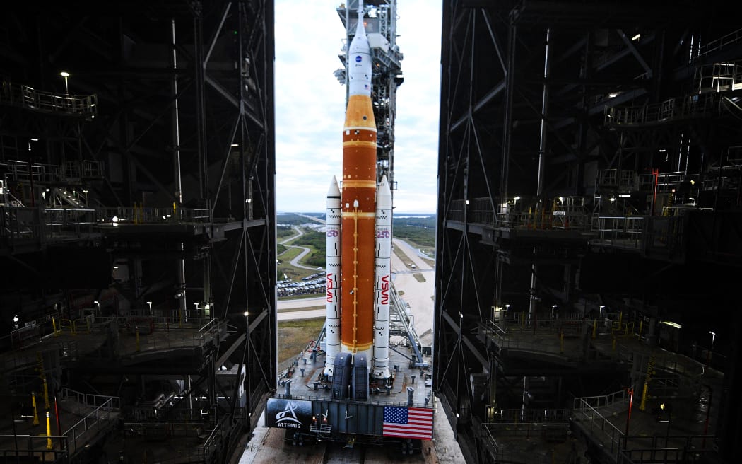 NASA's Artemis II Space Launch System rocket and Orion spacecraft are rolled out of the Vehicle Assembly Building to Launch Pad 39B at Kennedy Space Center in Florida on January 17, 2026, ahead of the crewed lunar mission. (Photo by Jim WATSON / AFP)