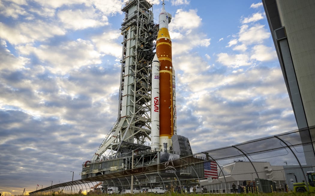NASA's Artemis II Space Launch System rocket and Orion spacecraft are rolled out of the Vehicle Assembly Building to Launch Pad 39B at Kennedy Space Center in Florida on January 17, 2026, ahead of the crewed lunar mission. (Photo by Jim WATSON / AFP)