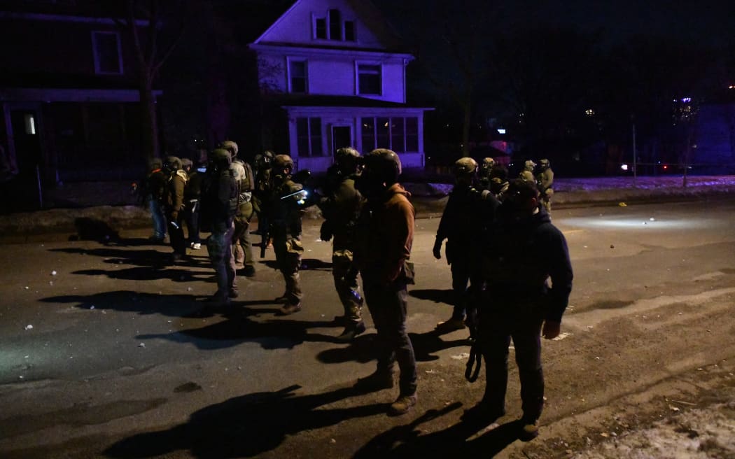Federal law enforcement agents and police officers in riot gear aim smoke crowd-control devices to disperse protesters following the shooting of a Venezuelan man by a Immigration and Customs Enforcement (ICE) agent in Minneapolis, Minnesota, on January 14, 2026. A federal immigration agent shot a man January 14 in Minneapolis, city officials said, urging the public to "remain calm" a week after agents shot and killed an American woman in the same city.
Minneapolis Police Chief Brian O'Hara said the shooting resulted from a struggle in front of a residence between a man and an Immigration and Customs Enforcement (ICE) agent on the north side of the city. (Photo by Octavio JONES / AFP)