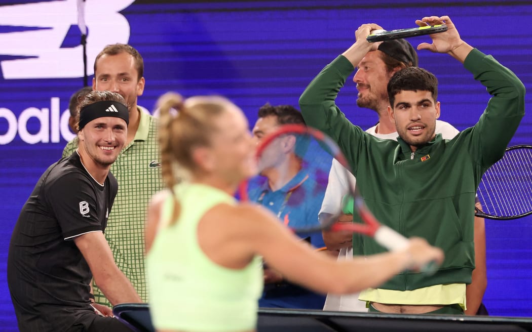 Germany’s Alexander Zverev (L), Russia’s Daniil Medvedev (2nd L) and Spain’s Carlos Alcaraz react during the 1 Point Slam exhibition event ahead of the 2026 Australian Open at Rod Laver Arena in Melbourne on January 14, 2026. (Photo by DAVID GRAY / AFP) / - IMAGE RESTRICTED TO EDITORIAL USE - STRICTLY NO COMMERCIAL USE --