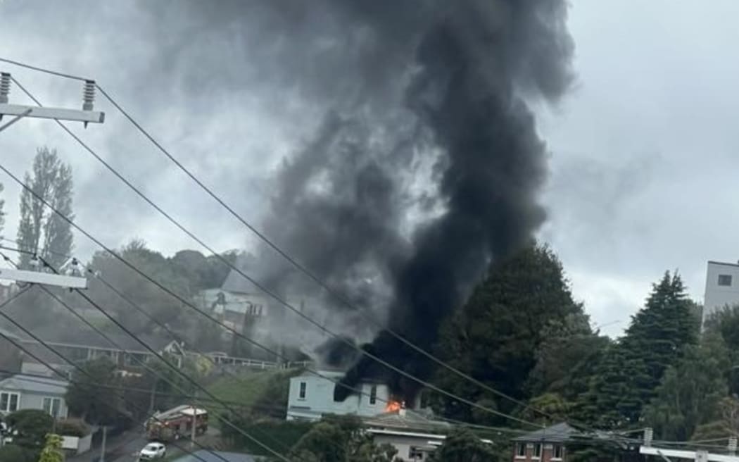 Fire and Emergency has sent out a smoke warning in Dunedin as crews battle a fire in the Roslyn Scout Hall.