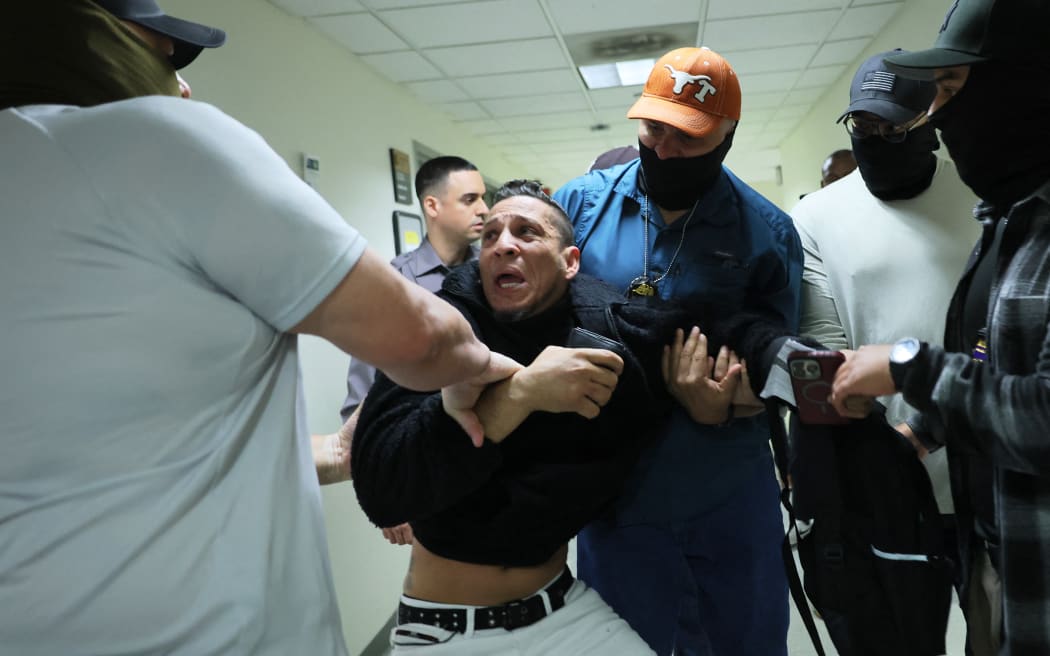 NEW YORK, NEW YORK - OCTOBER 27: A man seeking asylum from Colombia is detained by federal agents as he attends his court hearing in immigration court at the Jacob K. Javits Federal Building on October 27, 2025 in New York City. Immigration and Customs Enforcement (ICE) agents and other federal agencies continue to detain people in immigration courts as they attend their court hearings, despite a government shutdown that is now in its 27th day, the second-longest shutdown in U.S. history. Michael M. Santiago/Getty Images/AFP (Photo by Michael M. Santiago / GETTY IMAGES NORTH AMERICA / Getty Images via AFP)