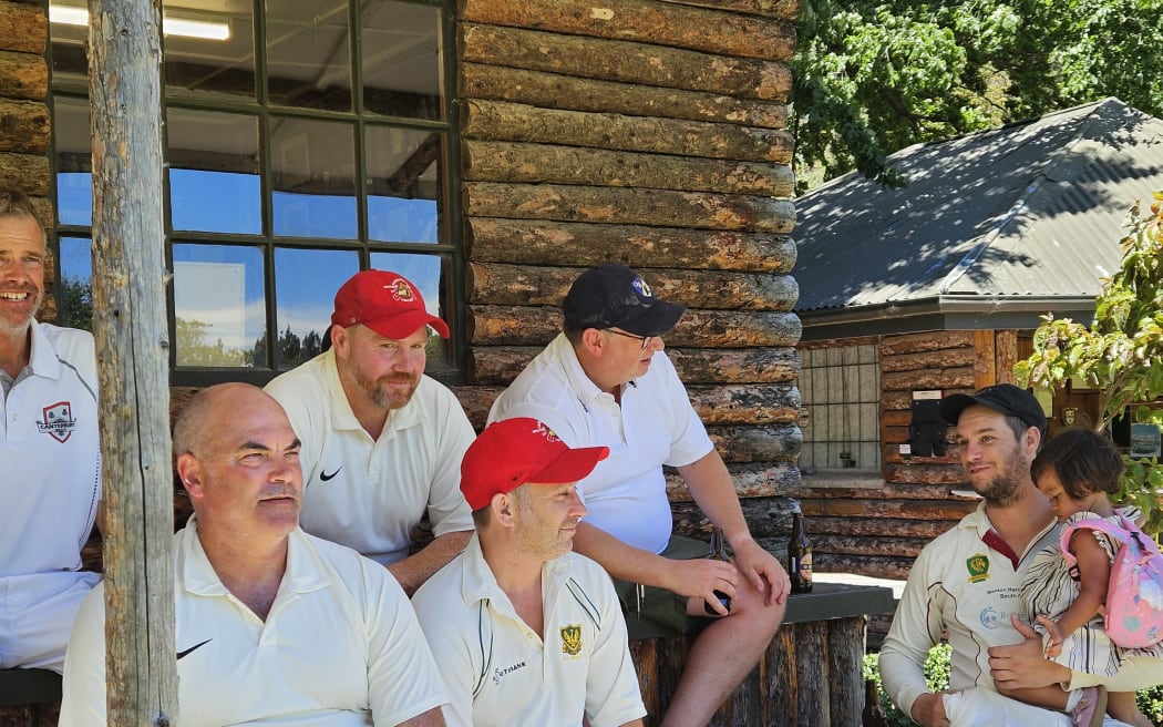 Valley of Peace players, captained by James Stokes (third from left), converse with one of the opposition's players