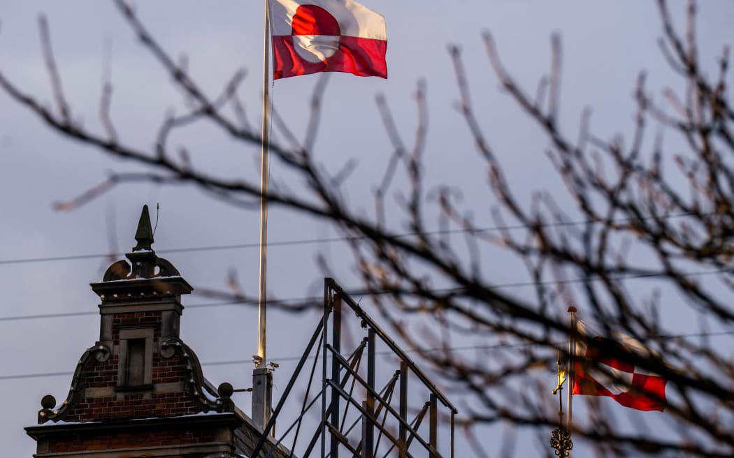 The Greenlandic flag (Erfalasorput) flies on the roof of Tivoli Castle in Copenhagen, on January 8, 2026. US President Donald Trump is discussing options including military action to take control of Greenland, the White House said on January 6, 2025, upping tensions that Denmark warns could destroy the NATO alliance. Trump has stepped up his designs on the mineral-rich, self-governing Danish territory in the arctic since the US military seized Venezuelan leader Nicolas Maduro on January 3, 2026. (Photo by Ida Marie Odgaard / Ritzau Scanpix / AFP) / Denmark OUT / DENMARK OUT / DENMARK OUT
