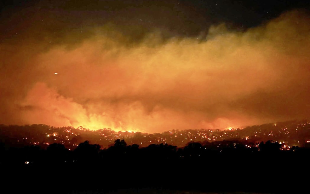 This handout photo from the CFA Wandong Fire Brigade posted on their Facebook page taken on January 7, 2026 and released on January 8 shows a bushfire burning near the town of Longwood, northern Victoria. Firefighters warned millions of Australians of 