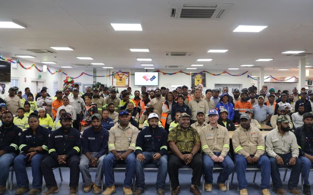 Papua New Guinea's prime minister James Marape (front and centre) meets with Exxon-Mobil workers.