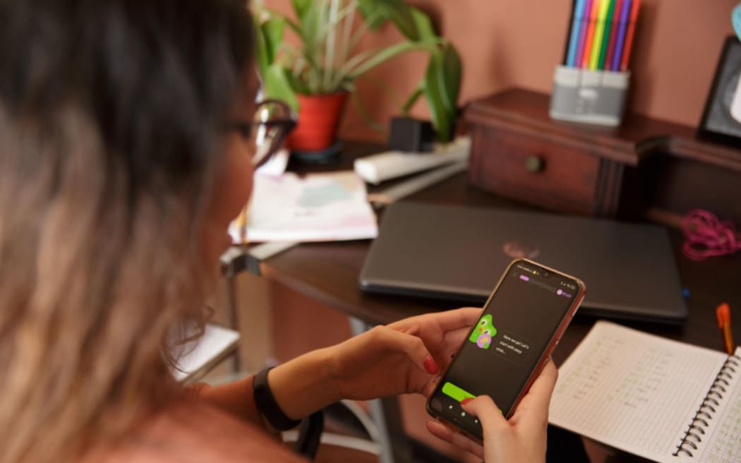 A woman uses the Duolingo app.