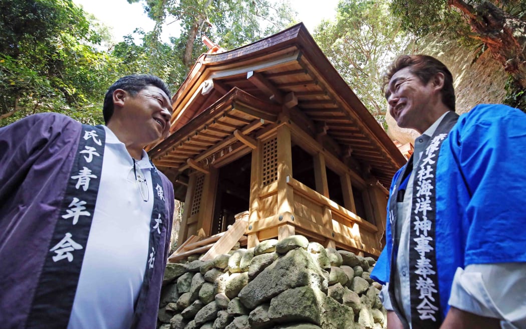 Shinto ritual is held at Munakata Grand Shrine's Okitsumiya shrine in Okinoshima Island, Munakata, Fukuoka Prefecture on Oct.13, 2018. The restoration works of the shrine building was completed on Oct.7 and the ritual was to bring back the God form temporary shrine. The island of Okinoshima, an ancient ritual site in the Munakata region of Fukuoka Prefecture was added to the U.N. cultural agency's list of the World Heritage Site in 2017.( The Yomiuri Shimbun ) (Photo by Ichiro Ohara / The Yomiuri Shimbun via AFP)