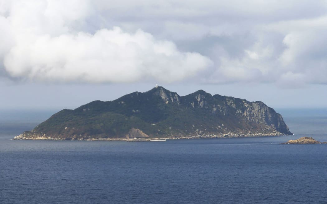 An aerial file photo shows Okinoshima, located in Genkai-nada Sea, in Munakata City, Fukuoka Prefecture onSep.5, 2015. The sacred island of Okinoshima and associated sites in the Munakata Region was added to UNeSCO World Heritage list in July 2017. ( The Yomiuri Shimbun ) (Photo by Hitomi Sadasue / The Yomiuri Shimbun via AFP)