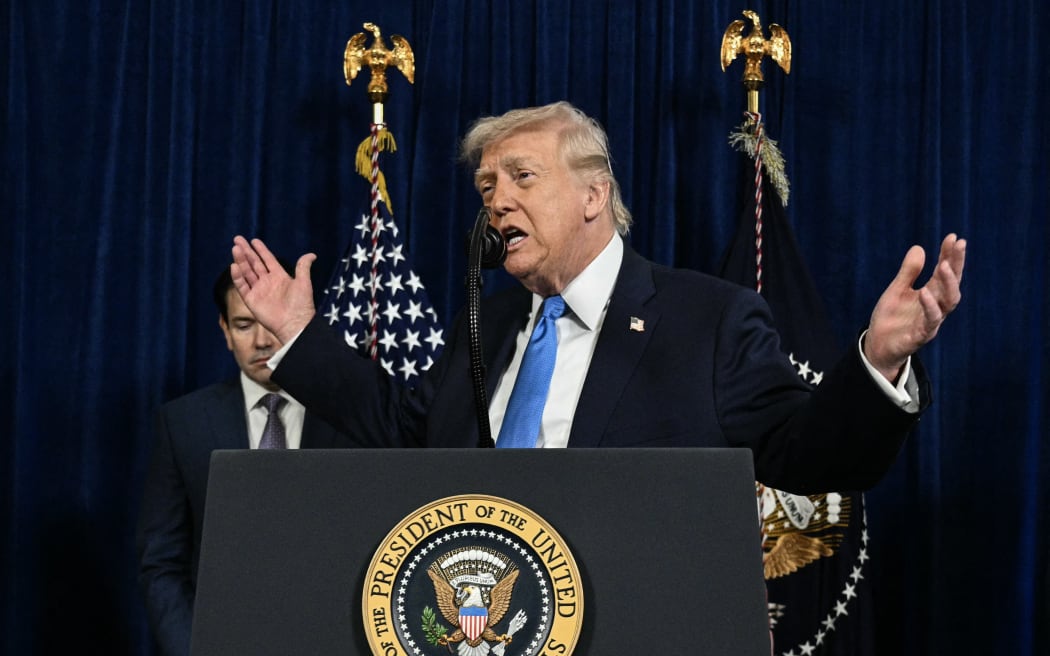 (L/R) US Secretary of State Marco Rubio looks on as US President Donald Trump speaks to the press following US military actions in Venezuela, at his Mar-a-Lago residence in Palm Beach, Florida, on January 3, 2026. President Trump said Saturday that US forces had captured Venezuelan leader Nicolas Maduro after launching a 