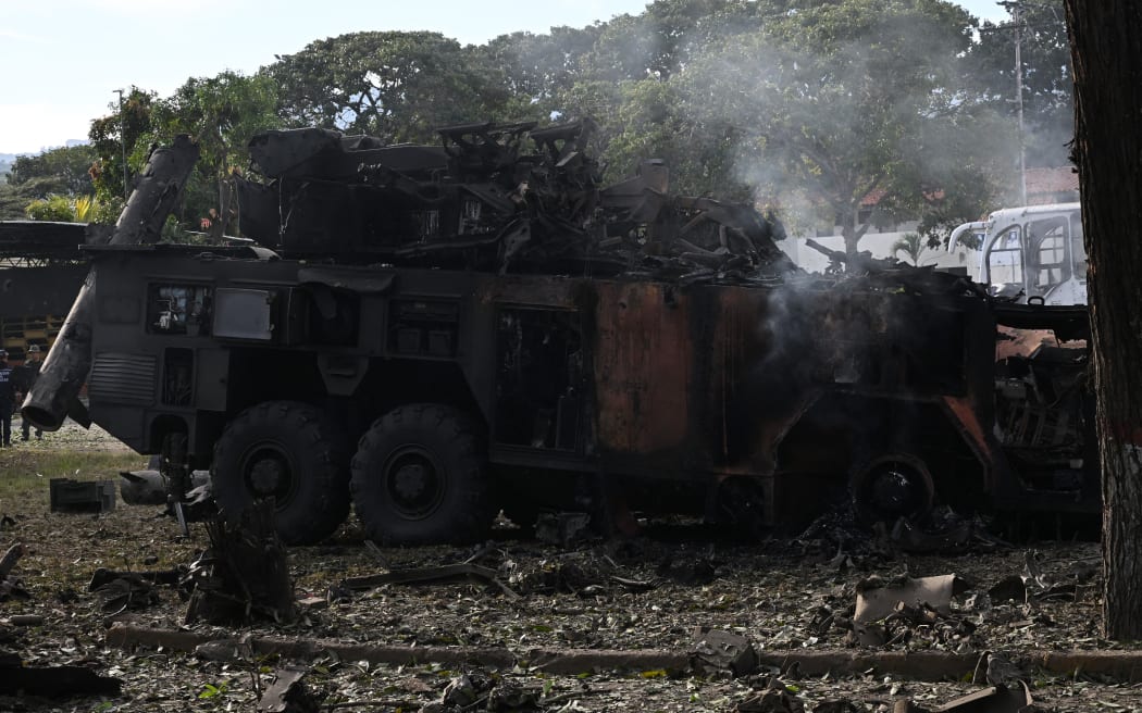 A burnt missile interceptor vehicle is seen at La Carlota air base in Caracas on January 3, 2026, after US forces captured Venezuelan leader Nicolas Maduro after launching a 
