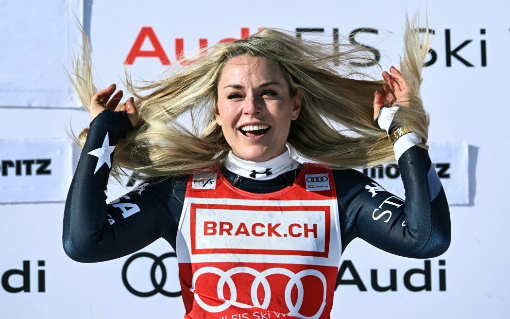 First-placed US Lindsey Vonn celebrates after winning the women's downhill at the FIS Alpine Ski World Cup 2025-2026, in St Moritz, Switzerland on December 12, 2025. (Photo by Fabrice COFFRINI / AFP)