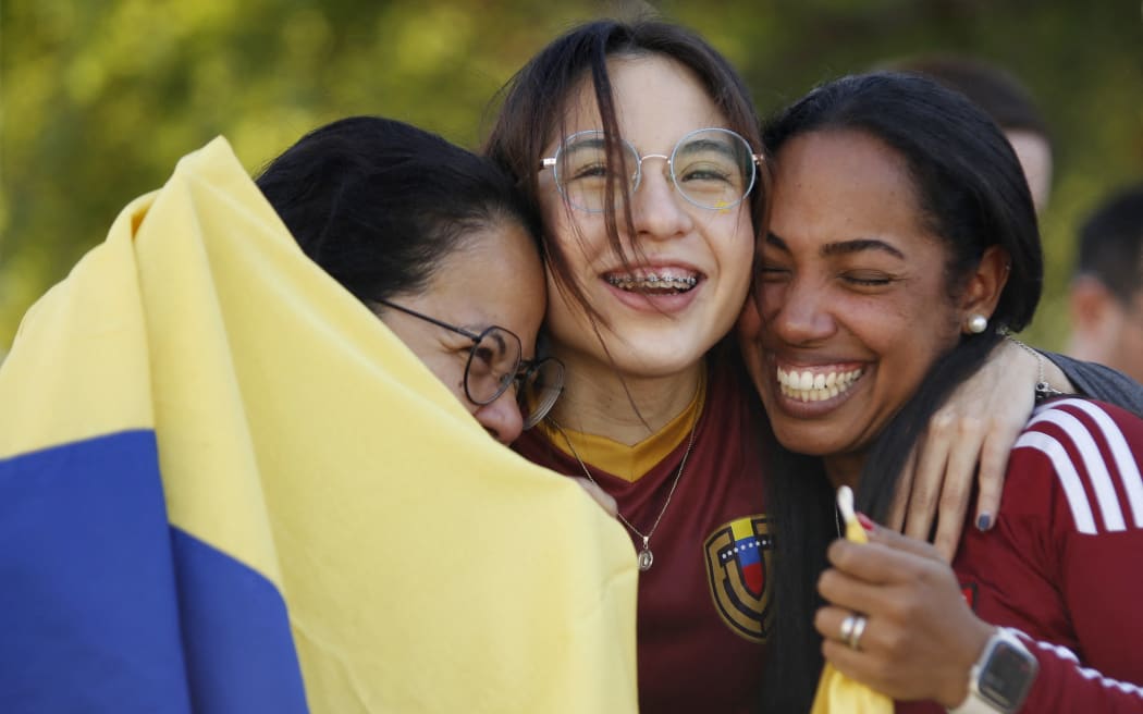 Venezuelans living in Monterrey react as they celebrate in Monterrey, Mexico.