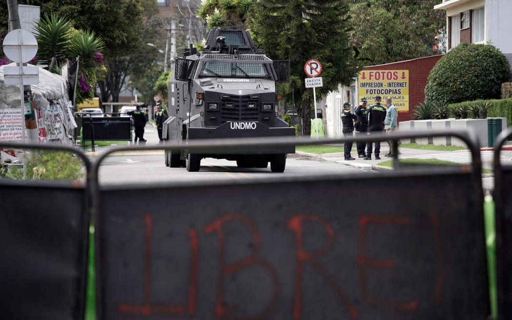 Police officers stand guard outside the US embassy in Bogota on January 3, 2026, during a demonstration against the US operation in Venezuela.