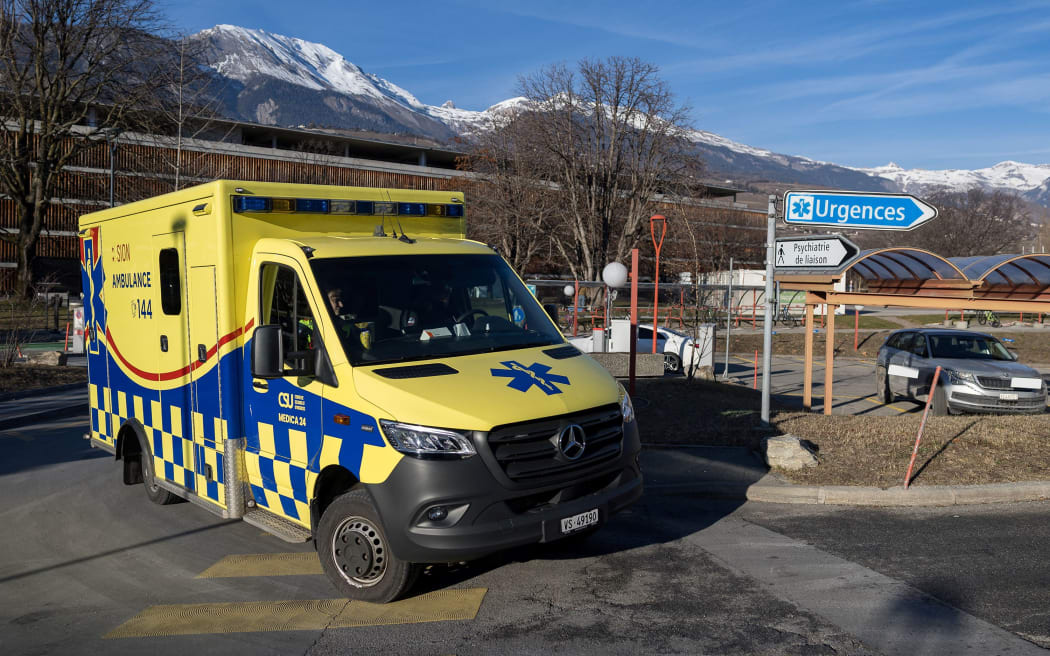 An ambulance arrives at Hospital du Valais, where the victims are being received following a fire at Le Constellation bar, in Sion, Switzerland, on Thursday.