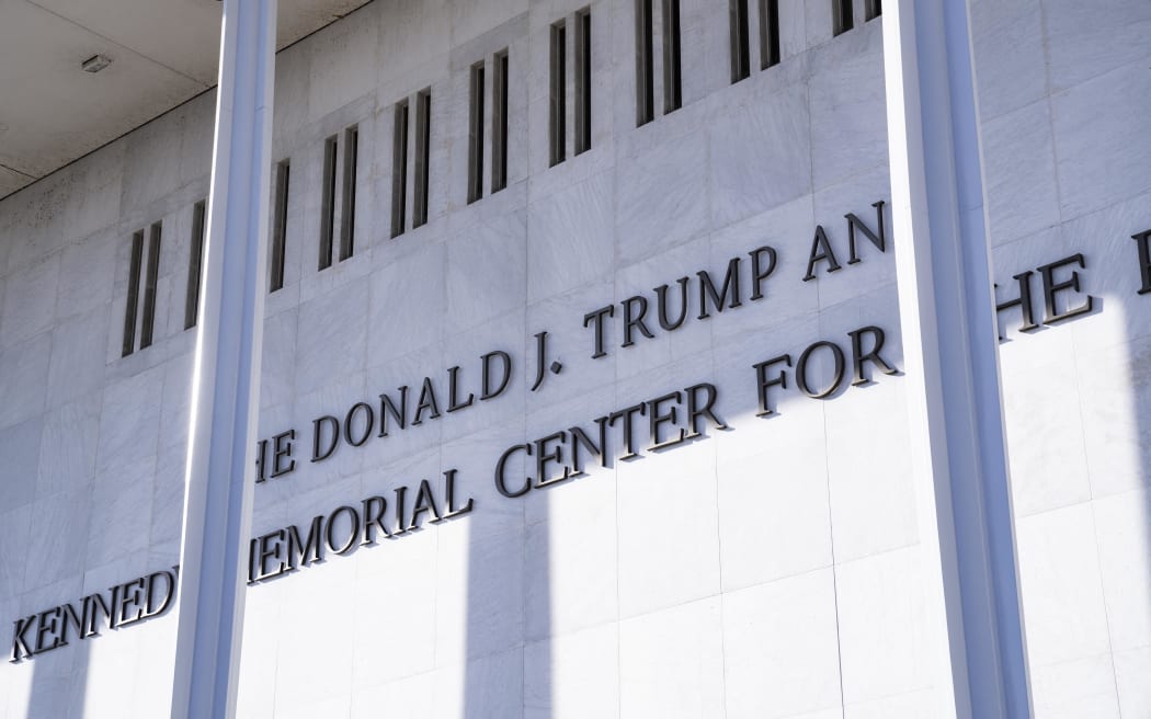 Workers finish installing President Donald Trump's name on the facade of the Kennedy Center in Washington, D.C., on December 19, 2025. (Photo by Andrew Thomas/NurPhoto) (Photo by Andrew Thomas / NurPhoto via AFP)