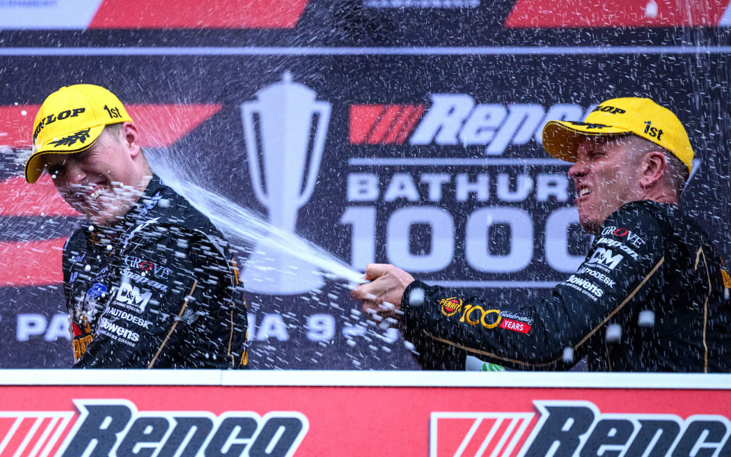 Matt Payne and Garth Tander of Grove Racing celebrate after winning the Supercars Championship Bathurst 1000 at Mount Panorama Circuit in Bathurst.