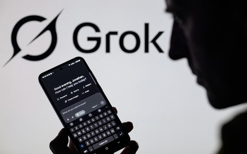 The Grok X AI app is used on a mobile phone with the Grok logo visible in the background on 8 March, 2025.