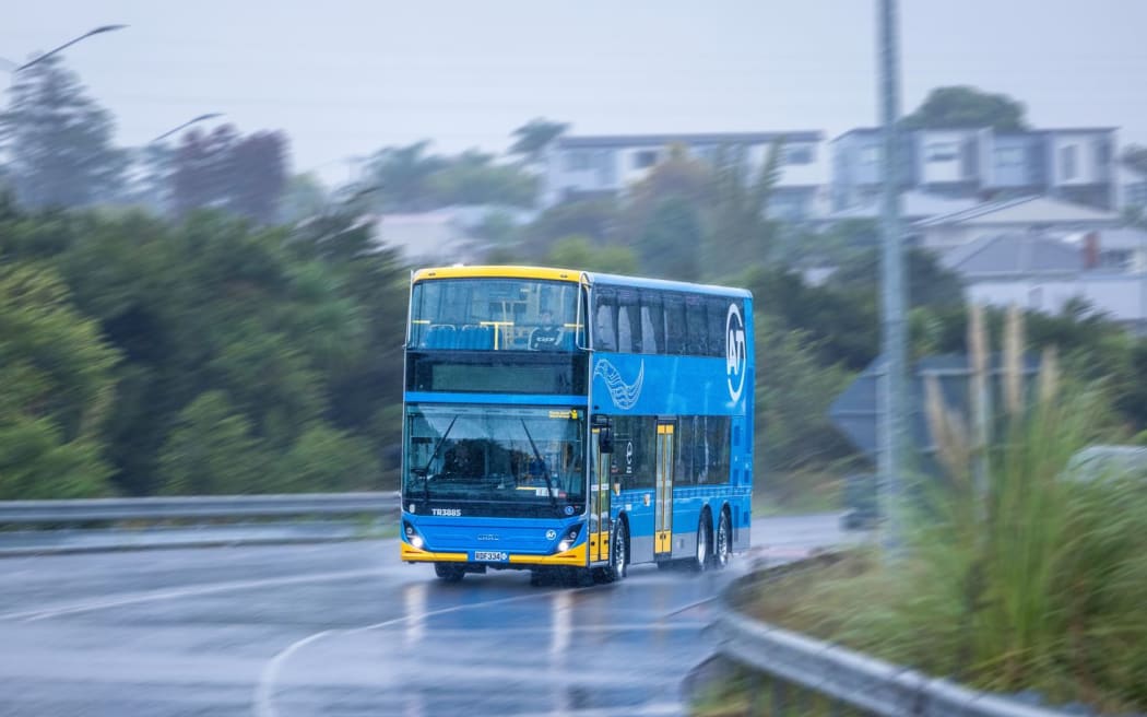 An electric double-decker bus in rainy Auckland conditions.