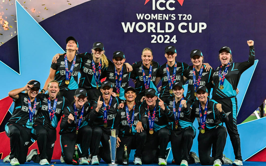 New Zealand's players celebrate with their winning trophy at the end of the ICC Women's T20 World Cup cricket final match between South Africa and New Zealand at the Dubai International Cricket Stadium in Dubai on October 20, 2024. (Photo by Giuseppe CACACE / AFP)