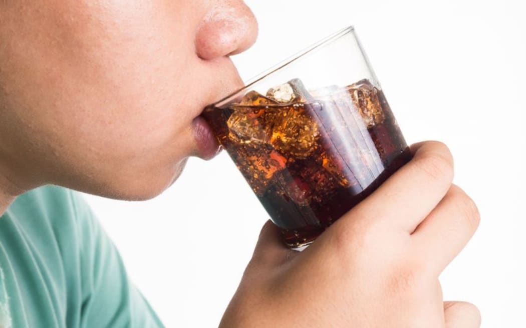 Generic. Teenager drinks soft drink.