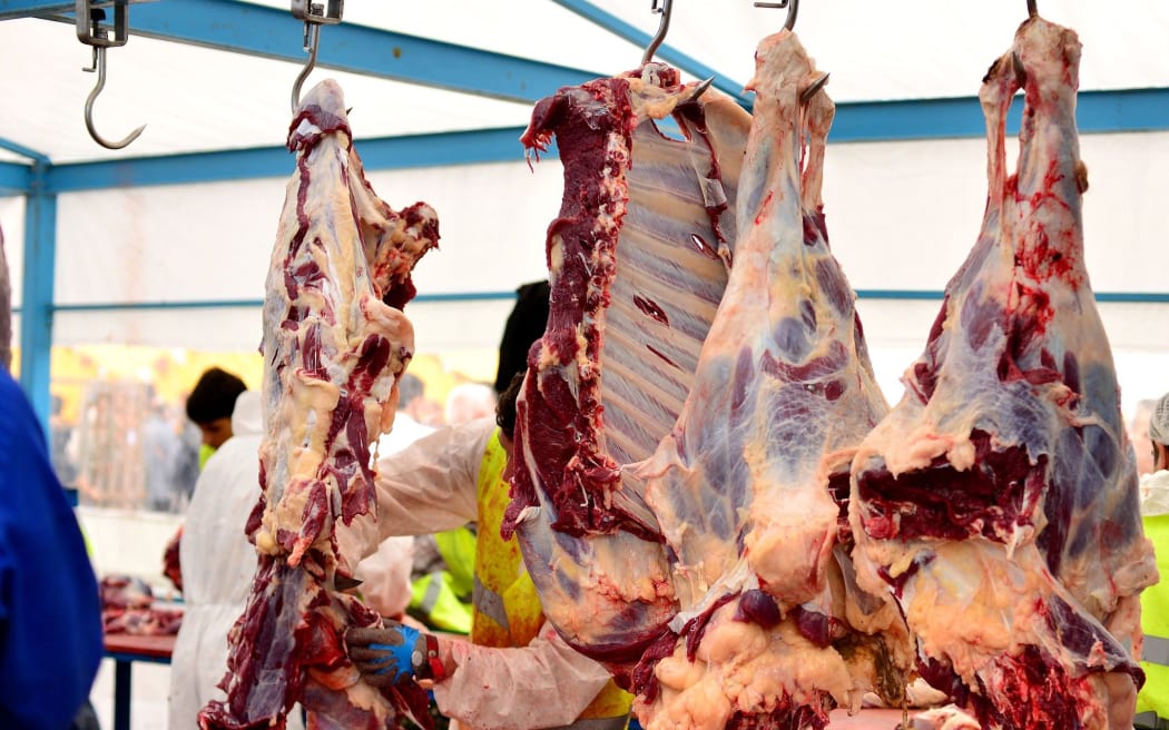 Beef hanging on hooks in an abbatoir