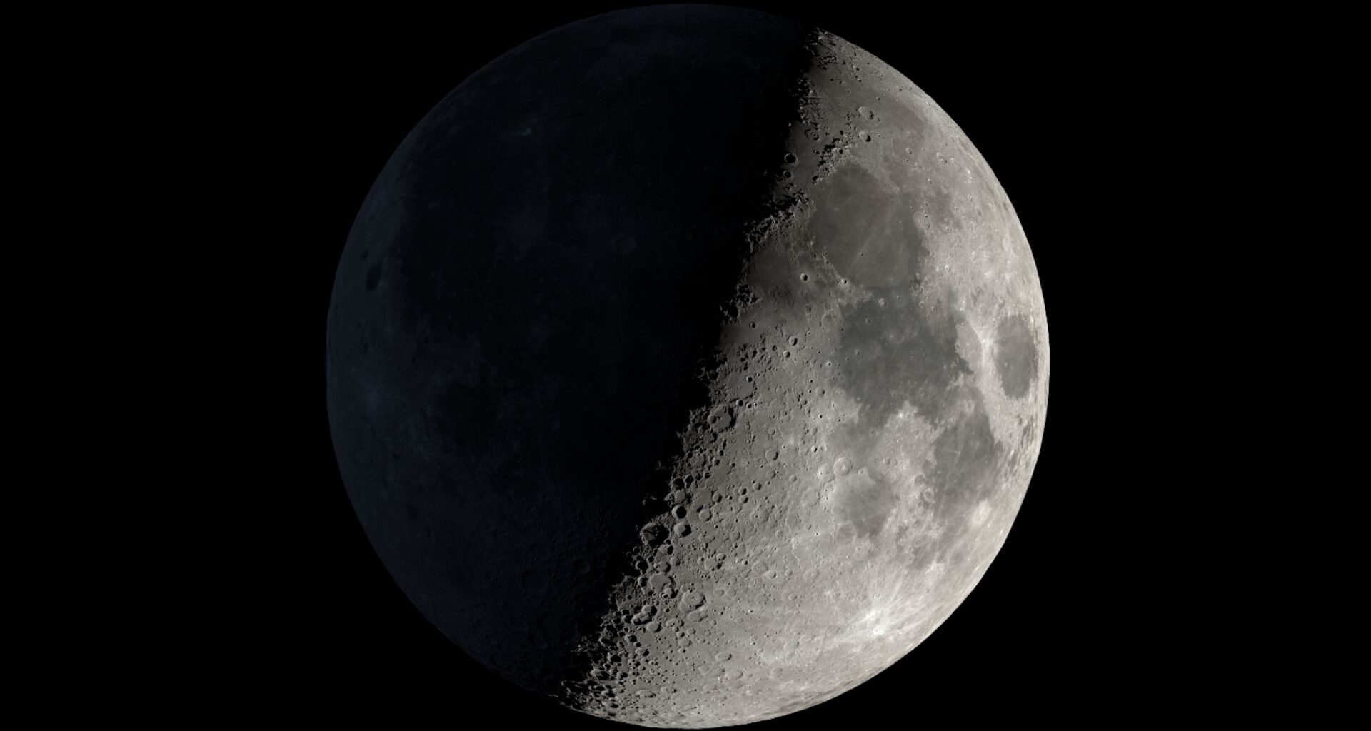 A graphic of the moon is pictured with its right half lit and its left in darkness against a black night sky.