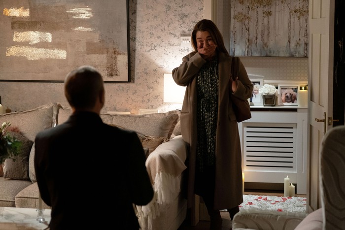 546956,TITLE:Eastenders A pleased Vicki holds her hand to her mouth in disbelief as Ross proposes to her in a scene from EastEnders