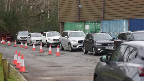 EDDIE MITCHELL A queue of cars at the water station at East Grinstead Rugby Club.