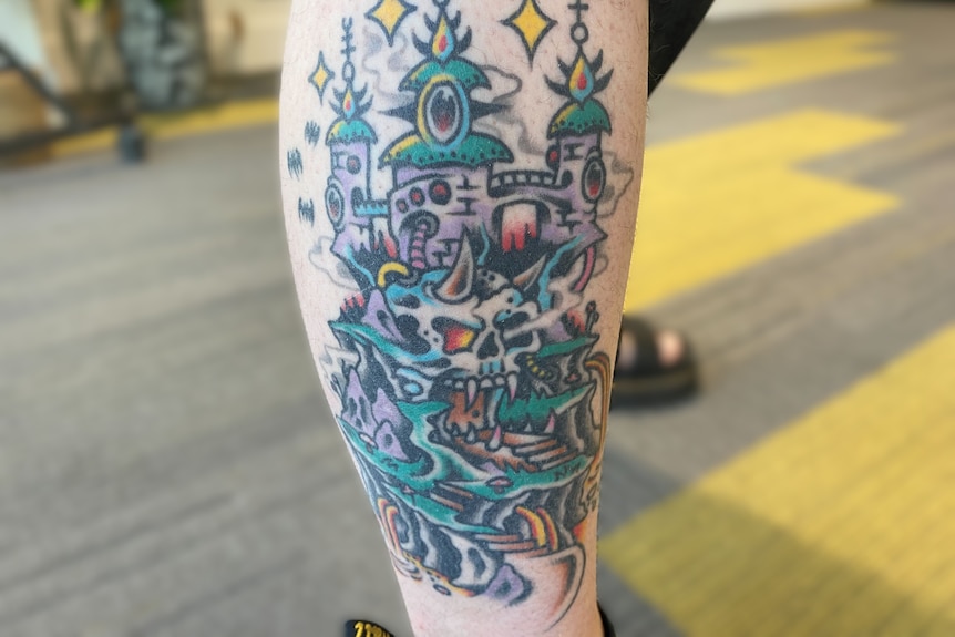 A colourful tattoo of a skull and castle in a fantasy neo-traditional style.