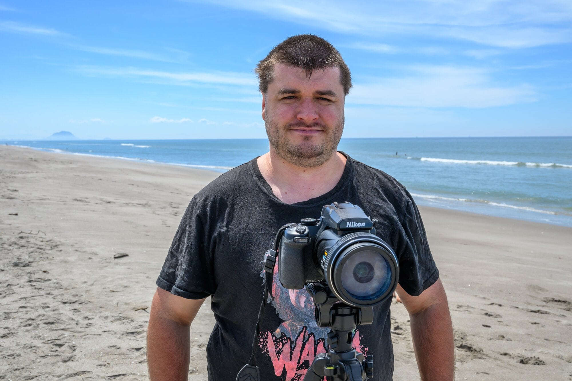  Che Whiteley with his camera on Pāpāmoa beach. Photo / David Hall