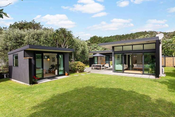 The two-bedroom bach on Karekare Road, in Karekare, was listed at the end of last year. Photo / Supplied