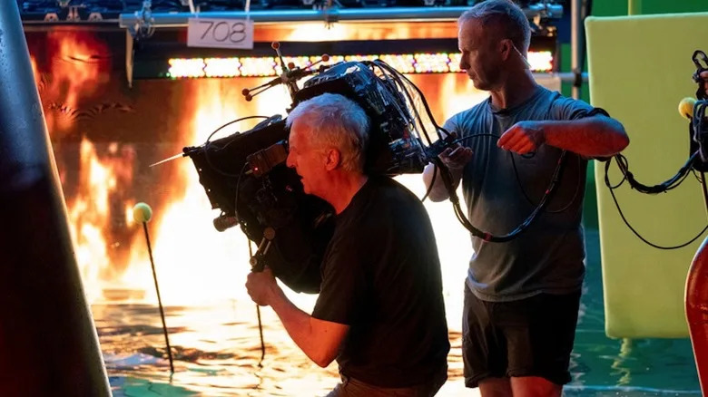James Cameron operates a camera in a fiery and watery environment on the set of "Avatar: The Way of Water"