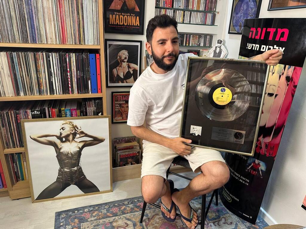 Madonna collector Avihay holds a framed platinum award for the artist’s debut album at his home in Israel. The rare industry piece, never intended for public sale, is a centerpiece in his archive and a symbol of Madonna’s early commercial breakthrough 