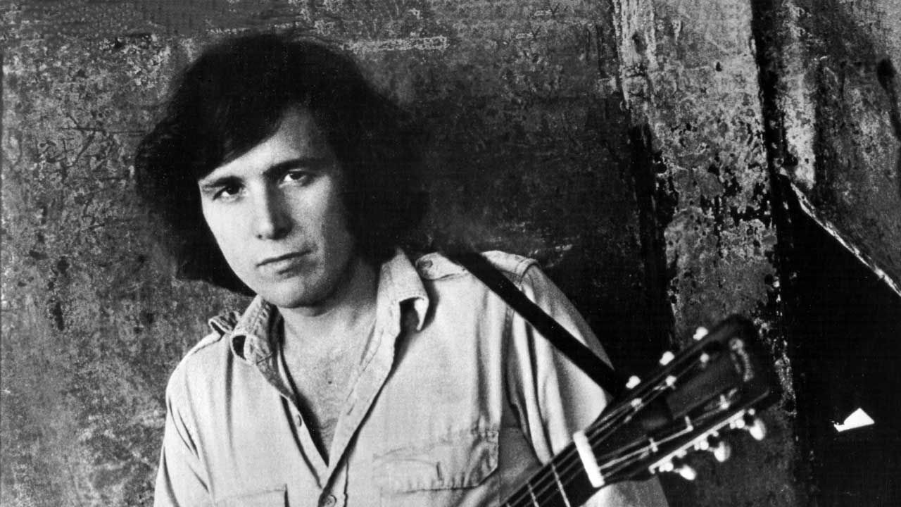 Don McLean posing with an acoustic guitar, 1971