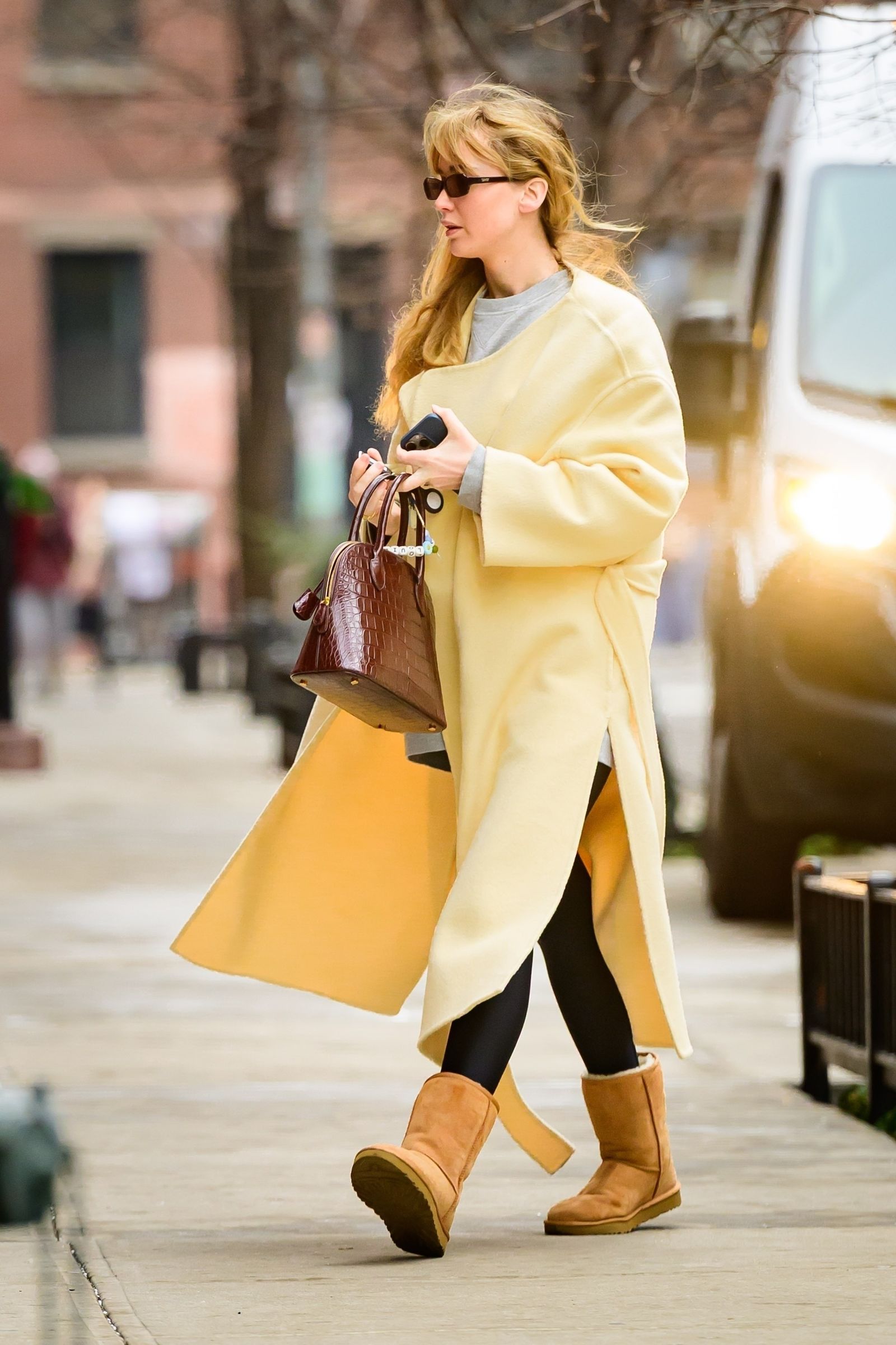 Image may contain Jennifer Lawrence Clothing Coat Accessories Bag Handbag Footwear Shoe Adult Person and High Heel